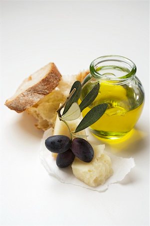 Black olives on twig, Parmesan, olive oil & white bread Stock Photo - Premium Royalty-Free, Code: 659-01862006