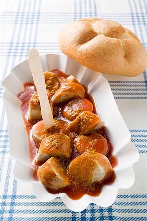 Sausage with ketchup & curry powder in paper dish, bread roll Stock Photo - Premium Royalty-Free, Code: 659-01862126