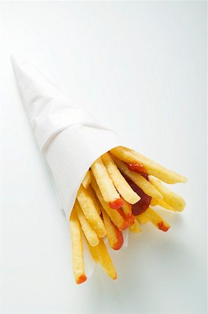 fries white background - Chips with ketchup in paper cone Stock Photo - Premium Royalty-Free, Code: 659-01862151