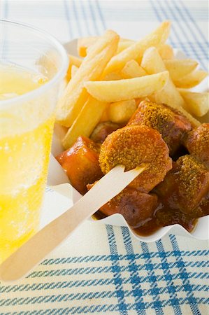 Currywurst (sausage with ketchup & curry powder) & chips, lemonade Stock Photo - Premium Royalty-Free, Code: 659-01862171