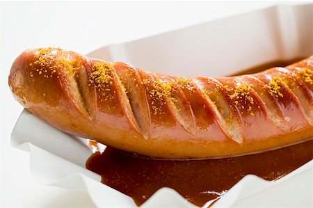 Currywurst (sausage with ketchup & curry powder) in paper dish Stock Photo - Premium Royalty-Free, Code: 659-01862195