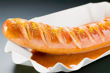 Currywurst (sausage with ketchup & curry powder) in paper dish Stock Photo - Premium Royalty-Free, Code: 659-01862192