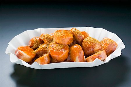 Currywurst (sausage with ketchup & curry powder) in paper dish Stock Photo - Premium Royalty-Free, Code: 659-01862205