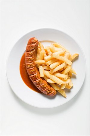 Currywurst (sausage with ketchup & curry powder) & chips on plate Stock Photo - Premium Royalty-Free, Code: 659-01862201