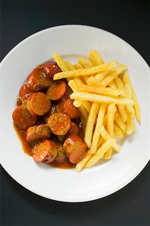 french fry top view nobody - Currywurst (sausage with ketchup & curry powder) & chips on plate Stock Photo - Premium Royalty-Free, Code: 659-01862212