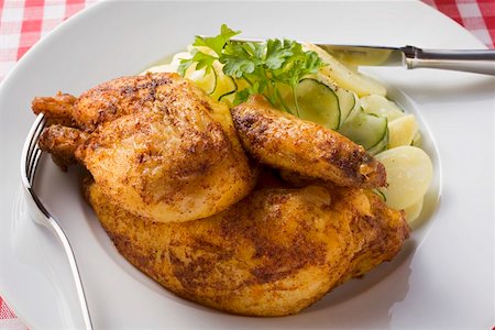 simsearch:659-01862234,k - Half a roast chicken with potato and cucumber salad Foto de stock - Sin royalties Premium, Código: 659-01862232