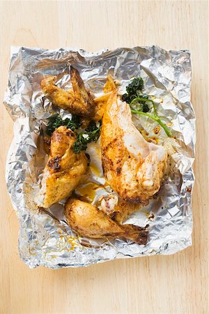 Pieces of roast chicken in aluminium foil Stock Photo - Premium Royalty-Free, Code: 659-01862267