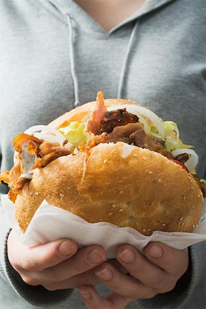 doner kebap kebab - Woman holding a döner kebab Stock Photo - Premium Royalty-Free, Code: 659-01862685