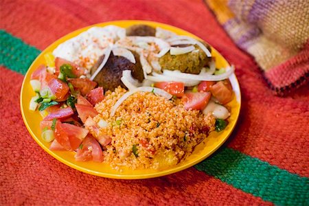 Falafel with couscous, tomato salad & yoghurt (N. Africa) Stock Photo - Premium Royalty-Free, Code: 659-01862744