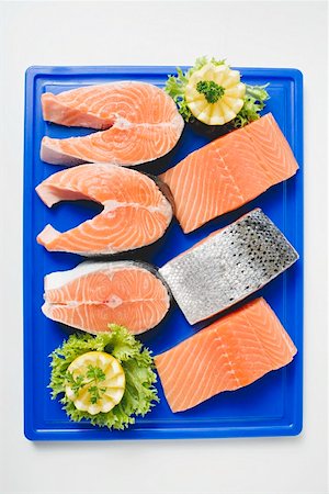 raw fish pieces - Fresh salmon cutlets and salmon fillets on chopping board Stock Photo - Premium Royalty-Free, Code: 659-01862752