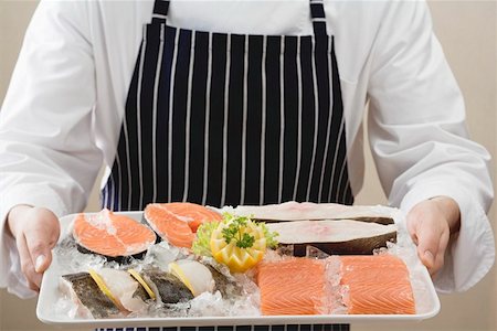 salmon steak - Person holding tray of salmon and sea bass pieces on ice Stock Photo - Premium Royalty-Free, Code: 659-01862806