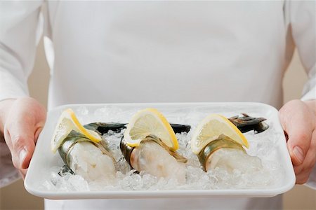 fresh prawn - Person holding tray of king prawns on ice Stock Photo - Premium Royalty-Free, Code: 659-01862816