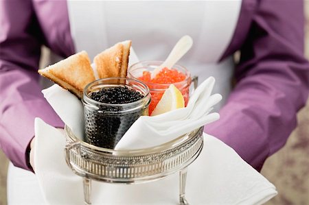 Chambermaid serving caviar and toast Stock Photo - Premium Royalty-Free, Code: 659-01862832