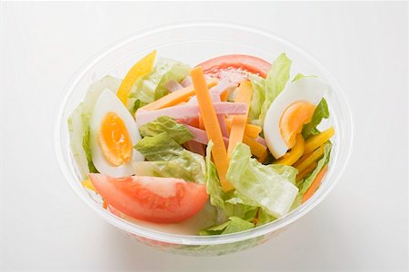 salad in container - Iceberg lettuce, ham, cheese, egg & tomatoes in plastic bowl Stock Photo - Premium Royalty-Free, Code: 659-01862904
