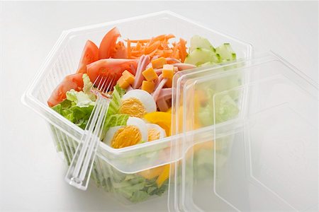 fast food salad - Iceberg lettuce, ham, cheese, egg & vegetables in plastic bowl Stock Photo - Premium Royalty-Free, Code: 659-01862909