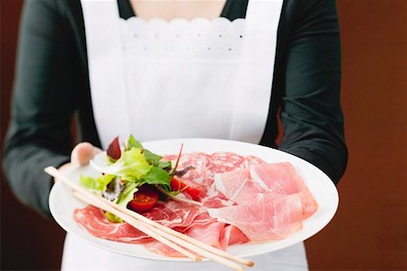 salami plate - Waitress serving Italian sausage platter with grissini Stock Photo - Premium Royalty-Free, Code: 659-01862902