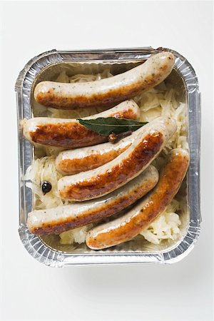 sauerkraut dish - Sausages with sauerkraut in aluminium container to take away Stock Photo - Premium Royalty-Free, Code: 659-01863054