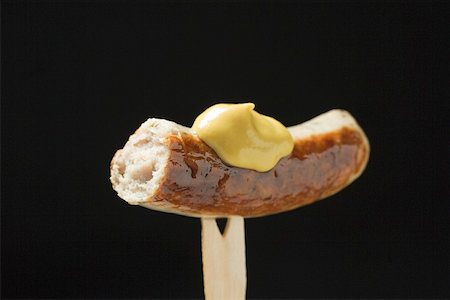 dollop - Sausage with mustard on wooden fork Stock Photo - Premium Royalty-Free, Code: 659-01863063