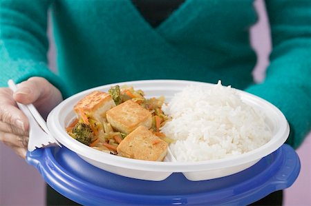 simsearch:659-02212761,k - Woman holding tofu, vegetables and rice on plastic plate Stock Photo - Premium Royalty-Free, Code: 659-01863083