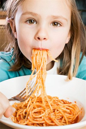 exceso - Girl eating spaghetti with tomato sauce Foto de stock - Sin royalties Premium, Código: 659-01863170