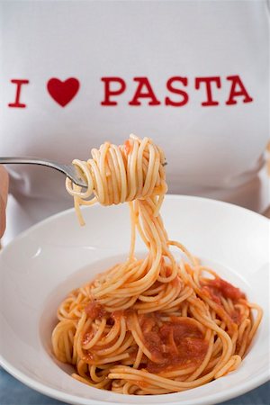 simsearch:659-01855701,k - Woman eating spaghetti with tomato sauce Stock Photo - Premium Royalty-Free, Code: 659-01863191