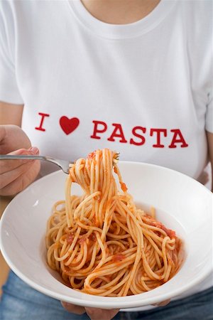 simsearch:659-01855701,k - Woman eating spaghetti with tomato sauce Stock Photo - Premium Royalty-Free, Code: 659-01863192