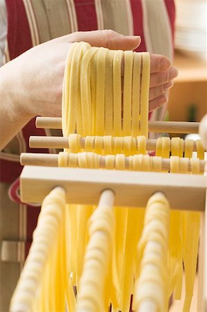 simsearch:659-01867277,k - Hanging home-made ribbon pasta up to dry Stock Photo - Premium Royalty-Free, Code: 659-01863218