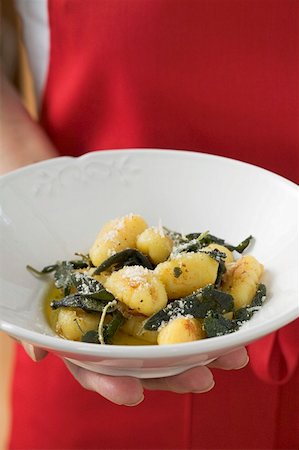 simsearch:659-01861281,k - Hand holding plate of gnocchi in sage butter Stock Photo - Premium Royalty-Free, Code: 659-01863213