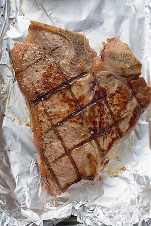 Grilled T-bone steak on aluminium foil Stock Photo - Premium Royalty-Free, Code: 659-01863327