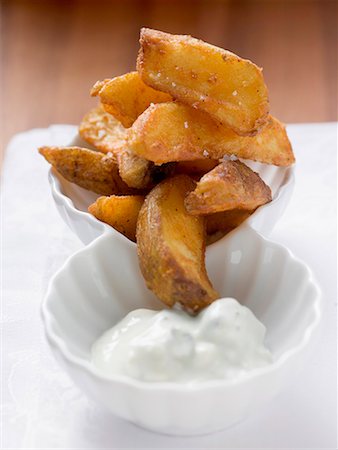 frite - Potato wedges with yoghurt dip Stock Photo - Premium Royalty-Free, Code: 659-01863362