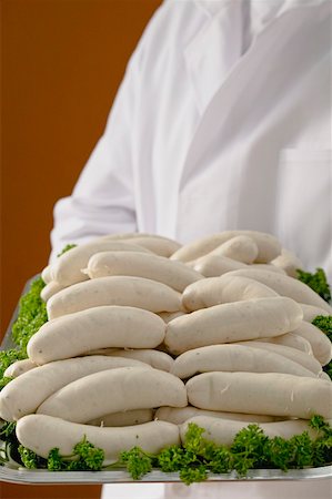 simsearch:659-01852769,k - Person holding tray of Weisswurst (white sausages) Foto de stock - Royalty Free Premium, Número: 659-01863421