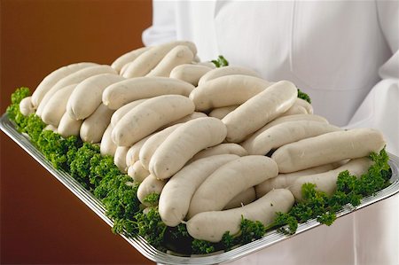 simsearch:659-01852769,k - Person holding tray of Weisswurst (white sausages) Foto de stock - Royalty Free Premium, Número: 659-01863422