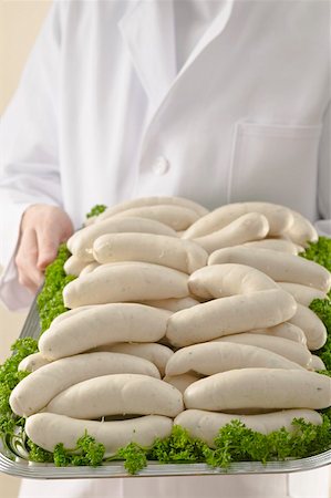simsearch:659-01852769,k - Person holding tray of Weisswurst (white sausages) Foto de stock - Royalty Free Premium, Número: 659-01863423