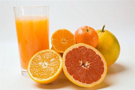 Glass of fruit juice and fresh citrus fruit Stock Photo - Premium Royalty-Free, Code: 659-01863545