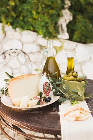 simsearch:659-01854208,k - Cheese, salami, olives, olive oil crackers on outdoor table Stock Photo - Premium Royalty-Free, Code: 659-01863594