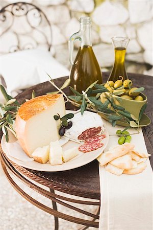 Cheese, salami, olives, olive oil crackers on outdoor table Stock Photo - Premium Royalty-Free, Code: 659-01863597