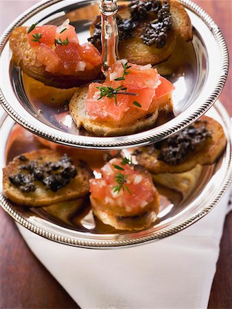 Bruschetta and crostini on tiered stand Stock Photo - Premium Royalty-Free, Code: 659-01863712