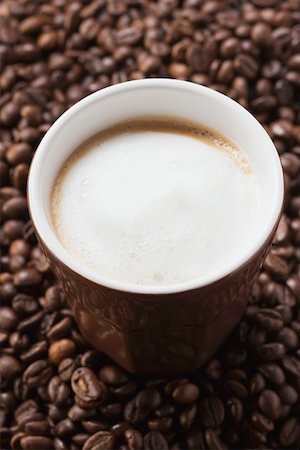 simsearch:659-07026887,k - Cup of coffee with milk froth on coffee beans Foto de stock - Sin royalties Premium, Código: 659-01863807