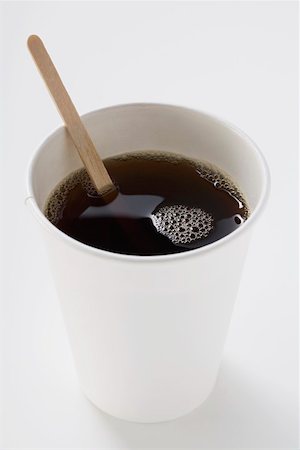 Black coffee in paper cup with wooden stirrer Stock Photo - Premium Royalty-Free, Code: 659-01863853