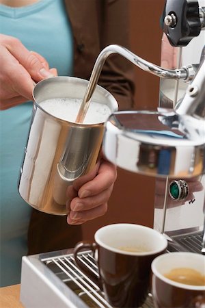 preparation of a cappuccino - Woman frothing milk with espresso machine Stock Photo - Premium Royalty-Free, Code: 659-01863868