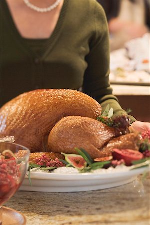 roast whole turkey - Woman with roast turkey in kitchen (Christmas) Stock Photo - Premium Royalty-Free, Code: 659-02214004