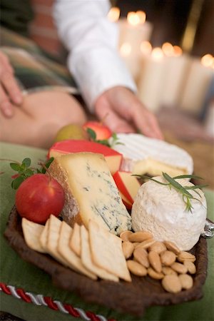 Hands serving cheeseboard with fruit and crackers Stock Photo - Premium Royalty-Free, Code: 659-02214009