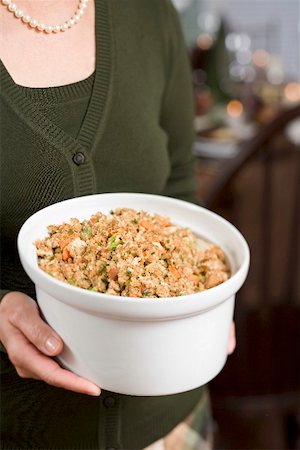 side dish - Woman holding large dish of bread stuffing (Christmas) Stock Photo - Premium Royalty-Free, Code: 659-02214000