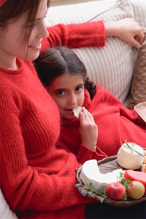 family relaxing at christmas - Mother and daughter on sofa with cheeseboard and crackers Stock Photo - Premium Royalty-Free, Code: 659-02214017