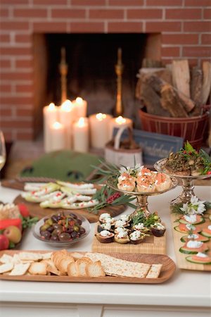 Assorted appetisers on table in front of fireplace (Christmas) Stock Photo - Premium Royalty-Free, Code: 659-02214022