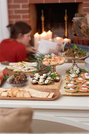 Assorted appetisers on table in front of fireplace (Christmas) Stock Photo - Premium Royalty-Free, Code: 659-02214023