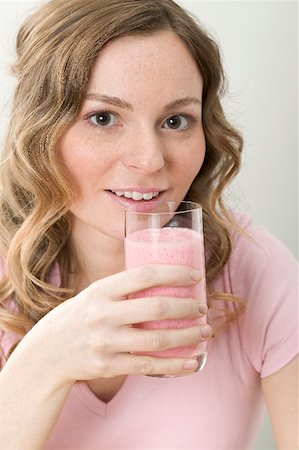 strawberry smoothie - Woman drinking strawberry shake Stock Photo - Premium Royalty-Free, Code: 659-02214164