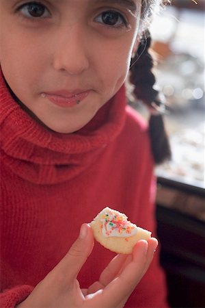 Girl eating Christmas biscuit Stock Photo - Premium Royalty-Free, Code: 659-02214205