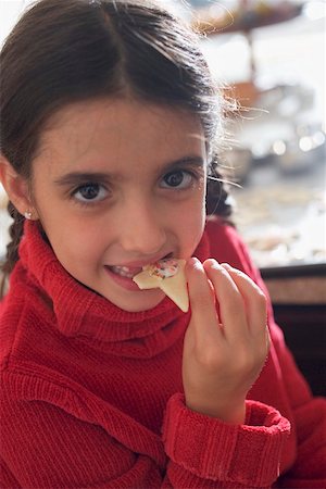 Girl eating Christmas biscuit Stock Photo - Premium Royalty-Free, Code: 659-02214206