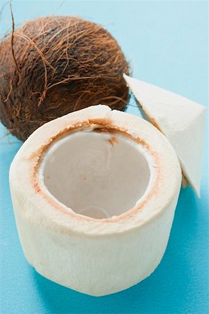 simsearch:659-02213538,k - The flesh of a coconut in front of whole coconut Foto de stock - Sin royalties Premium, Código: 659-02214285